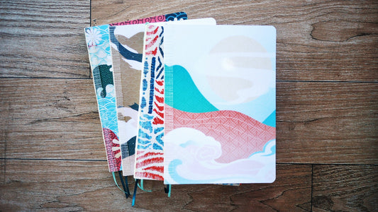 a5 colorful notebooks stacked together on the table